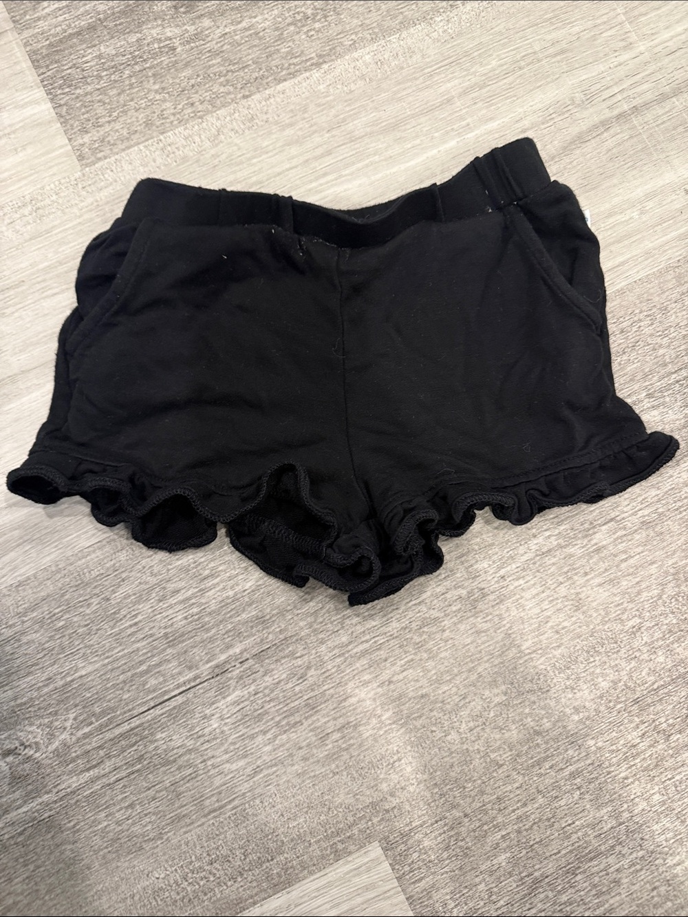Posh Peanut Black Ruffle Hem Shorts